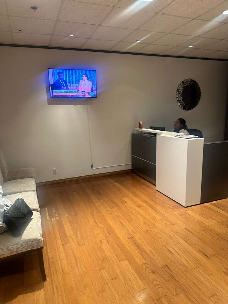 A woman sitting at a reception desk in an office