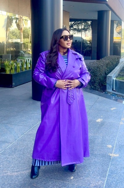 A lawyer in a purple trench coat